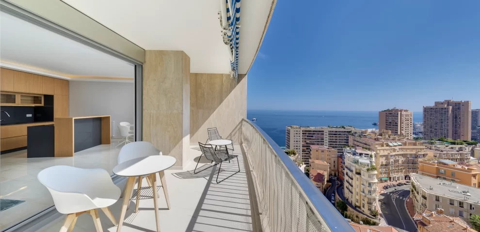 This is a view form a modern apartment in Château Périgord I in Monaco. you see the apartment interior with the floors, terrace, kitchen, and view of Monaco