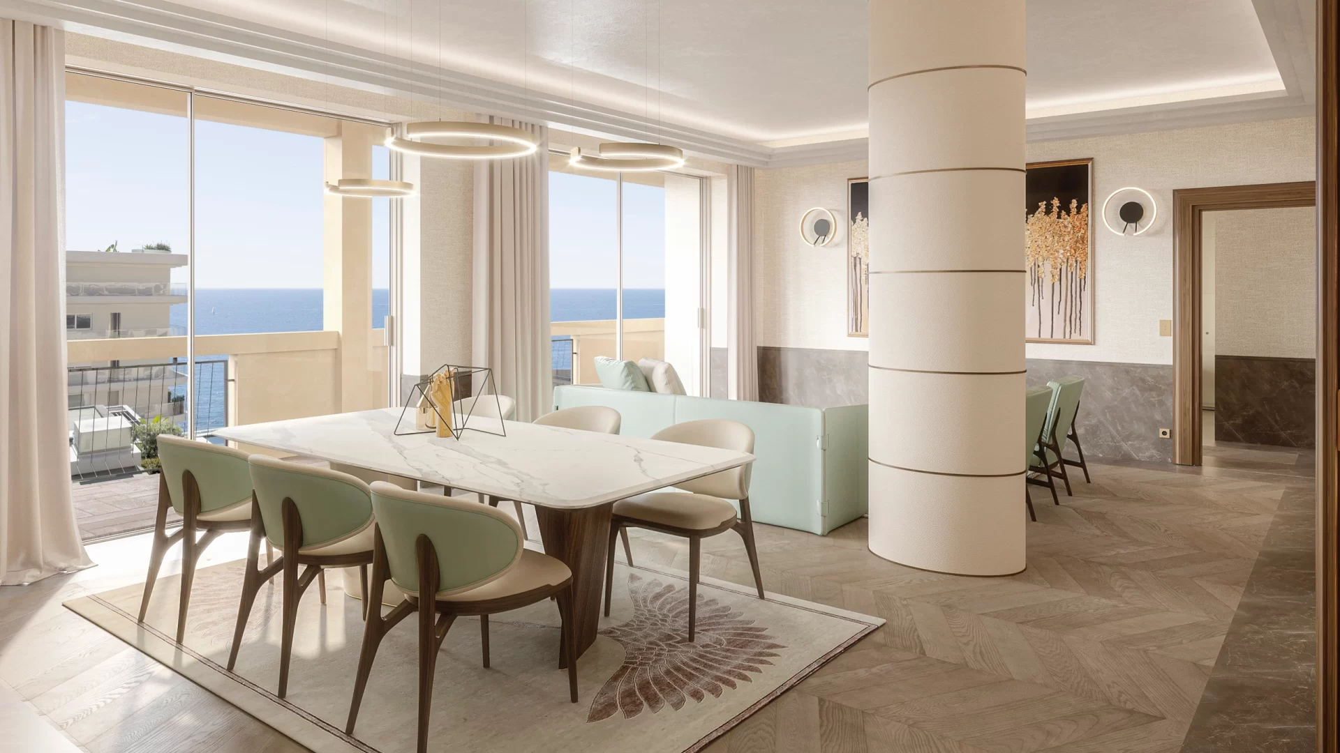 An interior photo of an apartment Baldo Realty Group is selling in Le Calpso Residence in LA Rousse Monaco. In this photo you see a modern living room and dining room with furniture. In the distance you see the terrace and sea view.