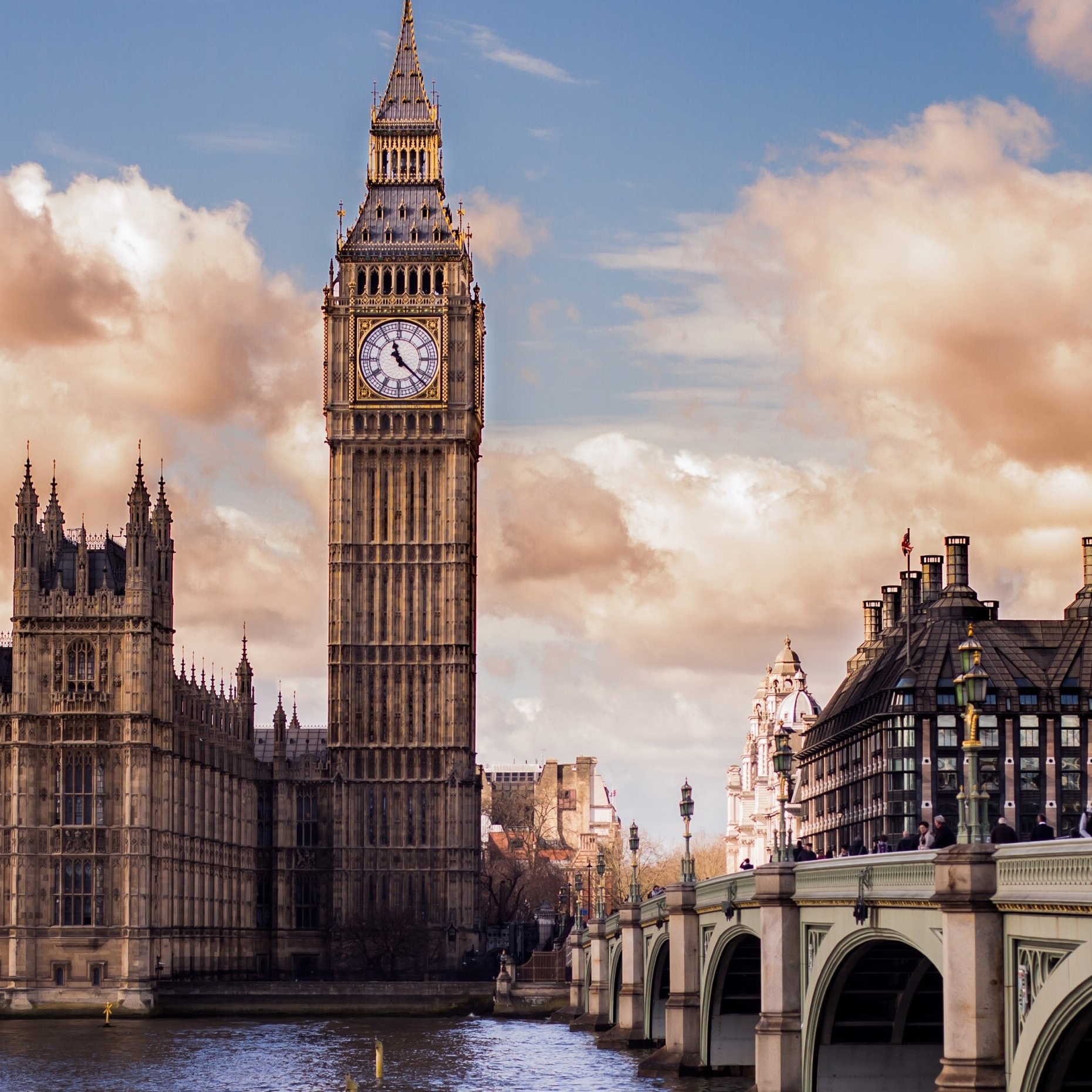 This is a banner photo of London in relation to the article about the UK Tax Reform. In this photo you see Big Ben, a Bridge and other buildings on the river
