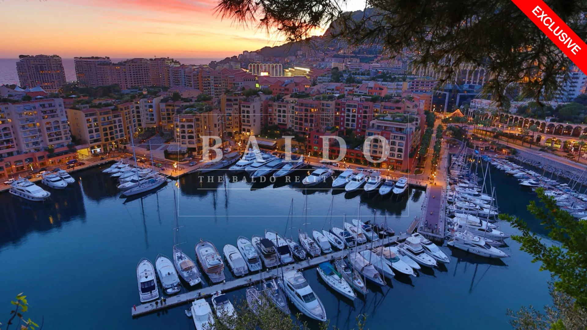 In this photo you see the view from Le Rocher in Monaco of Fontvieille. In Fontvieille you see the Port of Fontvieille, Yachts, Restaurants, and surrounding residential buildings