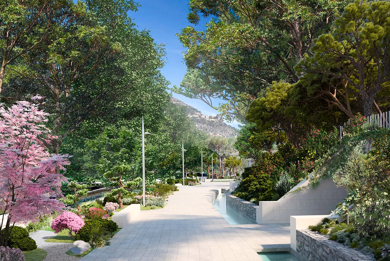 The park la pinède & la vallée at Mareterra Monaco. In the photo you see the park with trees, and a walkway