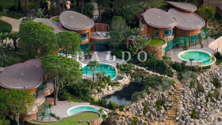 Aerial view of villas du sporting in Monaco. In this photo you see three villas surrounded by lush vegetation with pools in front