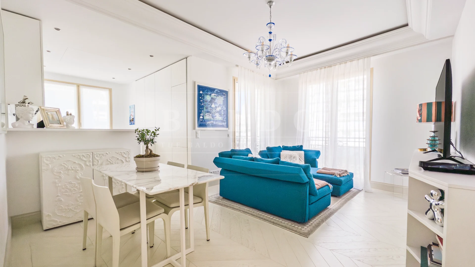 The living room, dining room, and kitchen of an apartment in the Villa Portofino residence in Monaco.