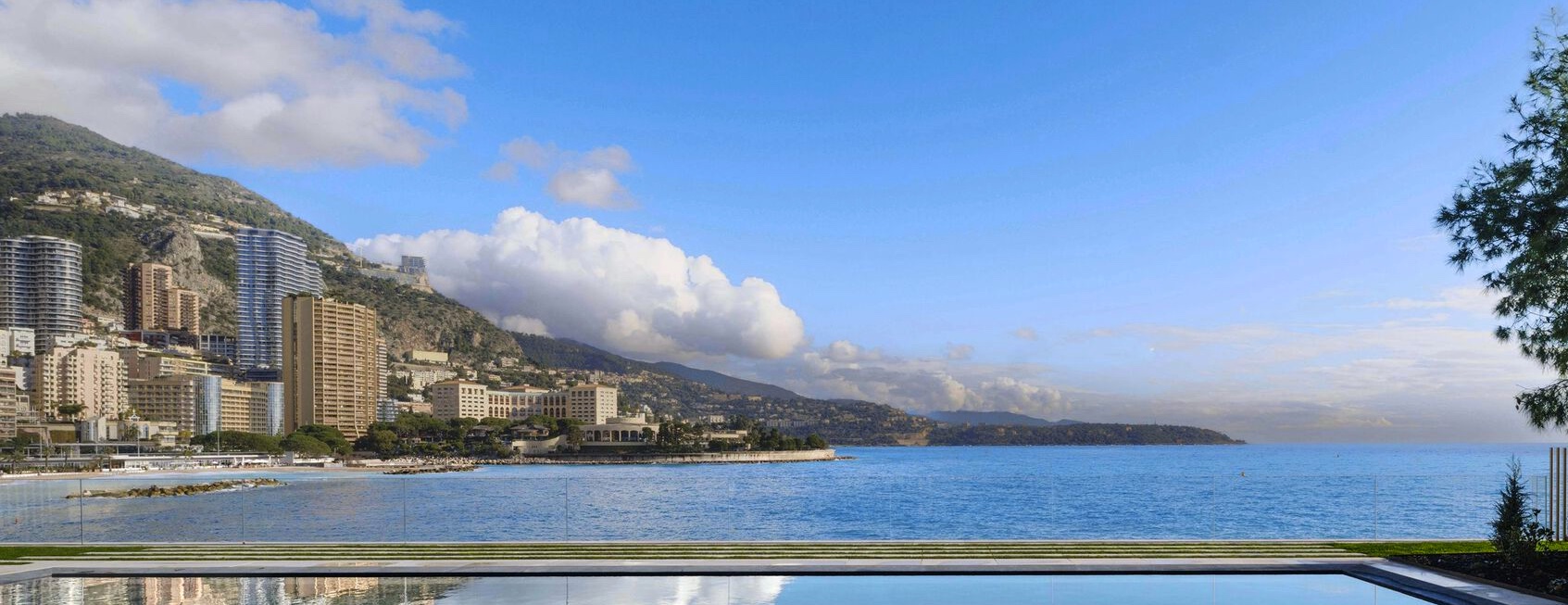 Villa Mareterra Monaco view. In this photo you see a pool, glass railing, and view of Larvotto Beach, Rocabella, Monte Carlo Bay hotel, Roquebrune-Cap-Martin, and the ocean