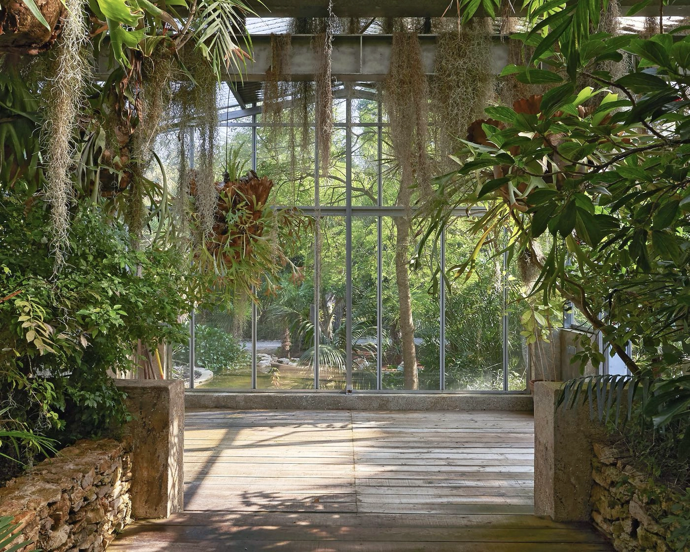 Interior of a heated greenhouse at Les Cèdres botanical garden with tropical plants