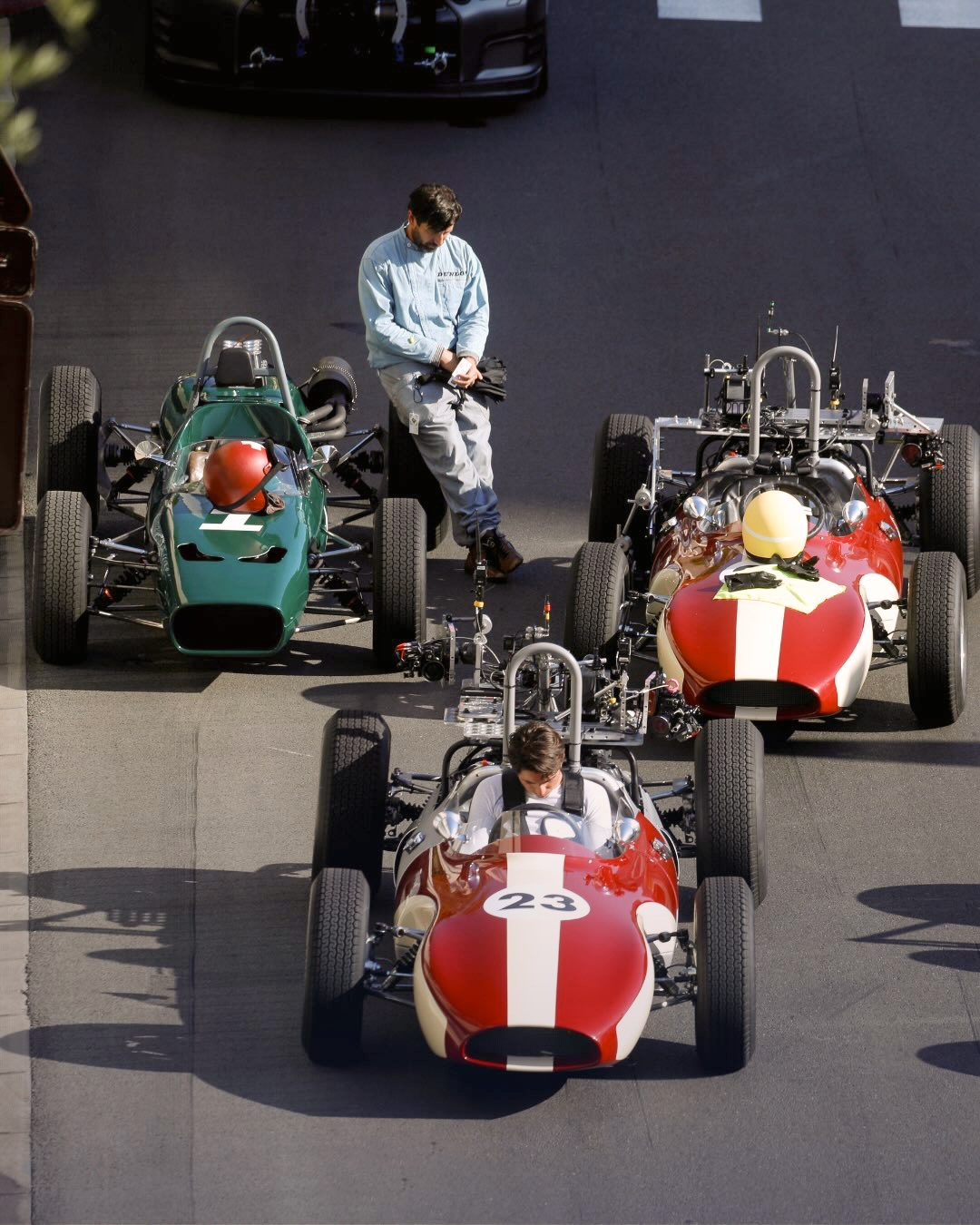 Vintage Formula 1 cars positioned on a closed street of the Monaco circuit