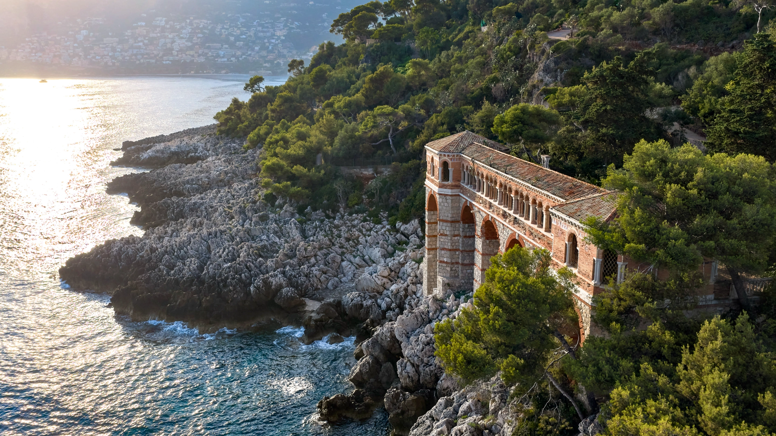 Neo-Byzantine cloister gallery of Villa Cypris on the rocks at the edge of the Mediterranean